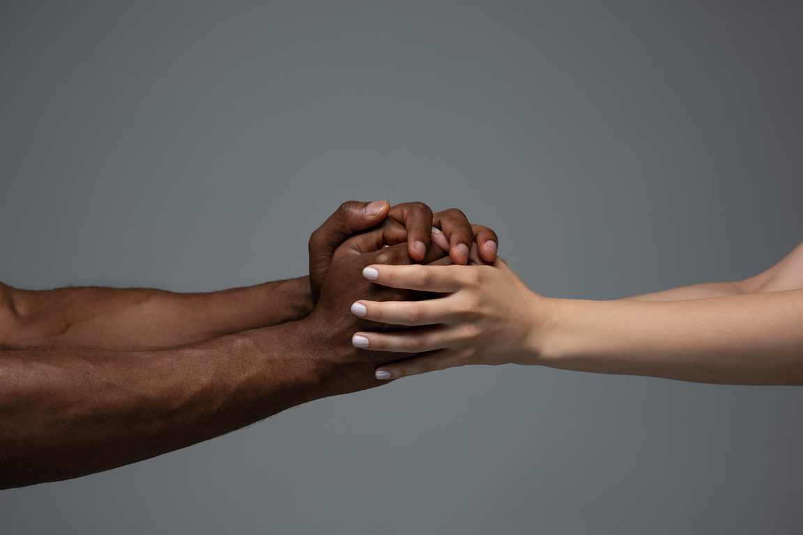 African and Caucasian Hands Together