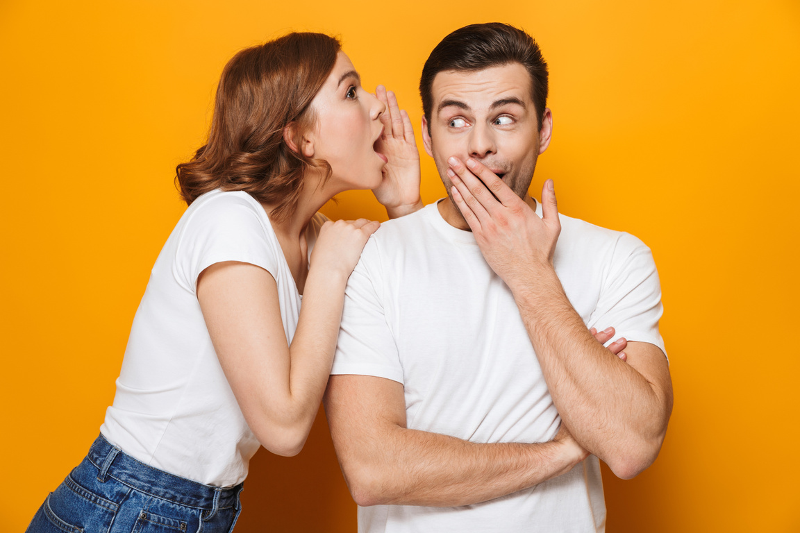 Excited Beautiful Couple Wearing White T-Shirts Standing